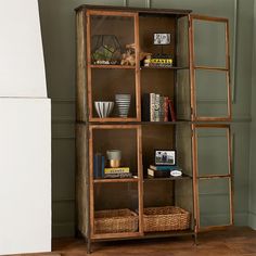 a book shelf with baskets and books on it