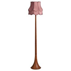 a wooden floor lamp with a pink shade on it's top and bottom half