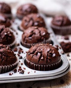 chocolate cupcakes in a muffin tin on a table