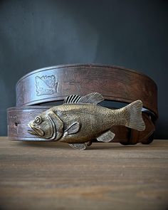 This fishing themed belt is handcrafted for fishermen, foresters and admirers of our beautiful wilderness. The full grain 3.5-4mm thick leather decorated with oak leaves, acorns and fish with a fish buckle will ensure that this belt will not be overlooked.  This belt can easily be used for everyday wear with jeans, but it will also stand out at themed fishing events. The belt is 4cm wide. To choose the correct size, please use one of the following methods. 1) Take a tape measure and a belt you c Golden Fish, Leather Decor, Fishing Theme, Fish Patterns, Oak Leaves, Suspender Belt, Slovakia, Bushcraft, Belt Size