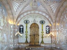 the interior of an old church with stained glass windows and decorative decorations on the walls