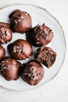 chocolate truffles on a plate with sea salt sprinkled on the top