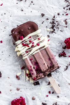 an ice cream sundae with raspberries and chocolate