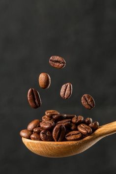 coffee beans falling into a wooden spoon