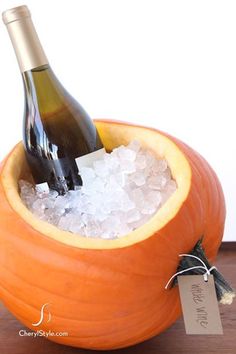 a bottle of wine in a pumpkin shaped ice bucket