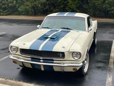 an old ford mustang sitting in a parking lot