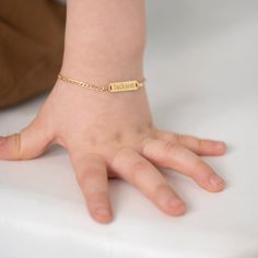 For moms in search of a creative and unique gift for their toddlers and little boys, this enchanting engravable plain rectangular identification tag bracelet is a thoughtful choice for any occasion. Crafted exclusively in 14k Yellow Gold, it ensures safety and comfort for babies and children during their everyday adventures. Order this classic ID bracelet today, and we'll ensure it's presented elegantly in its very own charming gift box, adding an extra touch of delight to your thoughtful gesture. Age Group: Fashionable for Babies, Toddlers and Children Material: 14k Yellow Gold Bracelet Length: 4.5 inches (11.5 cm) - Adjustable to 5.5 inches (14cm) Metal Stamp: 14k Gift Box Included Classic Personalized Rectangular Bracelets, Classic Personalized Rectangular Bracelet, Adjustable Name Bracelet With Rectangular Shape, Personalized Adjustable Rectangular Name Bracelet, Adjustable Rectangular Name Bracelet For Everyday, Personalized Rectangular Adjustable Name Bracelet, Classic Personalized Rectangular Name Bracelet, Rectangular Bracelet With Engraving Option For Everyday, Customizable Nameplate Bracelet For Everyday