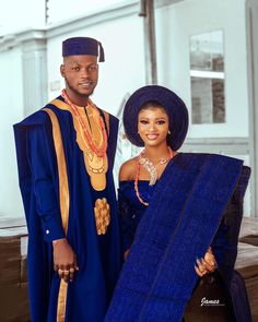 a man and woman dressed in traditional african clothing