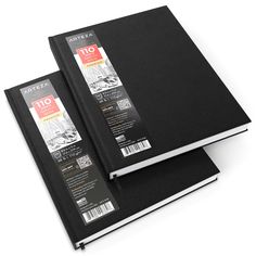 two black notebooks sitting side by side on top of each other in front of a white background