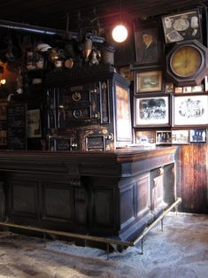 an old fashioned bar with pictures on the wall