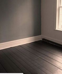 empty room with hard wood floor and blue walls