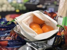 a bag full of oranges sitting on top of a scale