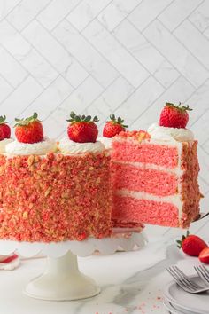 a strawberry layer cake with white frosting and strawberries on top