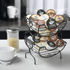 a stack of coffee cups sitting on top of a table next to a cup holder