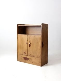 an old wooden cabinet sitting on top of a white floor