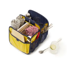 a blue and yellow bag with utensils in it