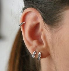 a close up of a person with ear piercings