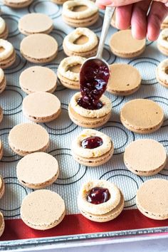 peanut butter and jelly macarons on a baking sheet with the words, how to make peanut butter and jelly macaroons