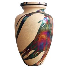 a vase with an artistic design painted on the outside and inside, sitting against a white background