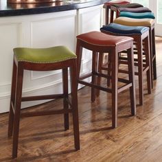 three stools are lined up in front of the bar