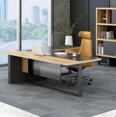 an office desk with a laptop on it in front of a bookcase and window