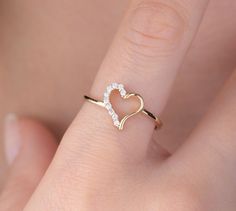 Our open heart ring is 14k solid gold. Its half of the heart is decorated with charming zircon stones. Our gold ring has a dainty style that can fit your all outfit. Our hollow heart ring makes happy your loved ones. It will be a perfect gift for valentine's day, mother's day, graduations, anniversaries, or birthdays. 🎁 If you want, you can add a gift note for your loved ones. It arrives in a special jewelry gift box. ✨ We respond to your questions happily. Your question will be answered within Yellow Gold Open Heart Wedding Ring, Open Heart Diamond Accented Promise Ring, Open Heart Diamond Accents Promise Ring, Dainty Heart-shaped Diamond Ring For Valentine's Day, Dainty Open Heart Ring For Anniversary, Valentine's Day Heart-shaped Dainty Diamond Ring, Valentine's Day Heart Shaped Diamond Ring, Diamond Open Heart Ring For Anniversary, Gold Heart-shaped Diamond Ring For Proposal