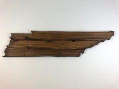 a piece of wood that is shaped like the state of mississippi on a white wall