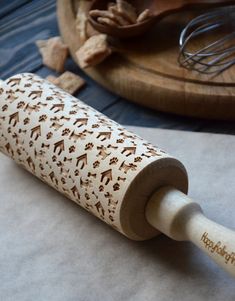 a wooden rolling pin sitting on top of a table