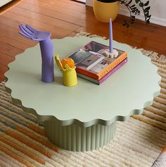 a table that has some books on it and a toy duck sitting on top of it