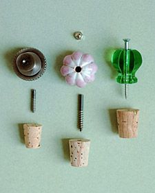 four corks with flowers and pins attached to them on a white surface, one has a screwdriver in the middle