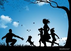 silhouettes of people and dogs playing in the grass under a tree with butterflies flying overhead