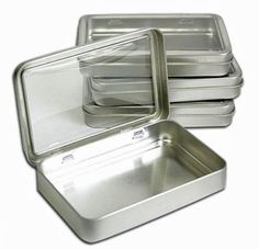 four square tins with lids are stacked on top of each other, one is empty