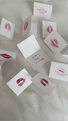 several pieces of paper with red lipstick prints on them