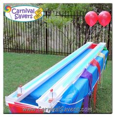 an inflatable water slide with balloons attached to it and the words carnival savers on