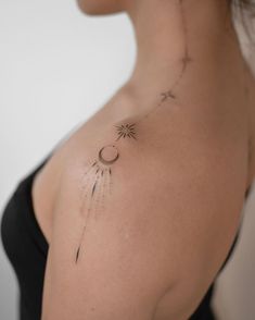 a woman with a sun and moon tattoo on her back