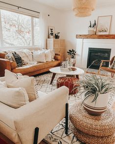 a living room with couches, chairs and a fire place in the center area