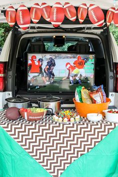 a football themed party is set up in the back of a van