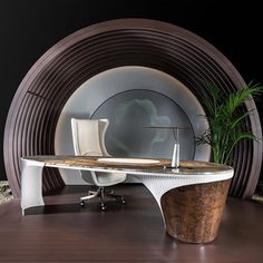 an office desk in front of a circular wall