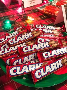 a table topped with lots of candy bar wrappers on top of a green plate