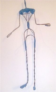 a wire sculpture is hanging on the wall