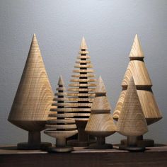 three wooden christmas trees sitting on top of a table