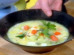 a bowl of soup with carrots and celery