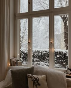 a living room filled with lots of windows covered in snow next to a window sill