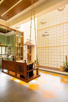 a living room filled with lots of furniture and hanging decorations on the ceiling over a tiled floor