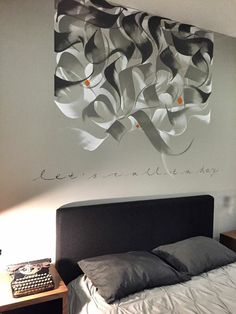 a bed sitting under a painting on the wall