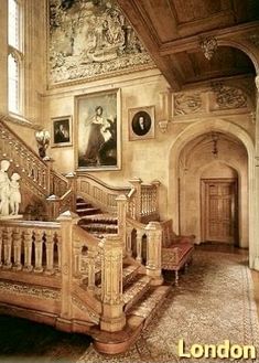 an ornate staircase with paintings on the walls