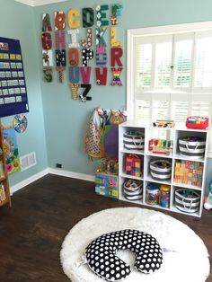 a child's playroom with toys and bookshelves