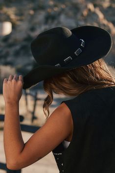 The iconic black cowboy hat you have all been waiting for is here... The McGraw is promised to add spice to every festival look you're planning this year. This hat provides a luxe look that we know you'll love. Style with your favorite cowboy boots and just about ANY dress for that dream western outfit you've been craving. **ALL ACCESSORIES ARE FINAL SALE** PRODUCT DESCRIPTION: - black cowboy hat - onyx stones throughout hat band - flexible brim to allow shaping as desired - raw edge brim - one Cowboy Hat Outfit Woman, White Cowboy Hat, Fringe Romper, Black Cowboy Hat, Cowboy Aesthetic, 12th Tribe, American Paint, Bridal Tops, Western Outfit