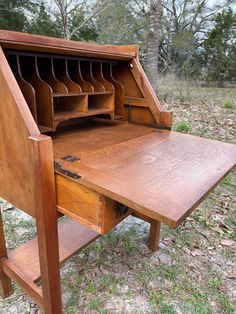 an old wooden desk with lots of drawers on it's top and bottom shelf