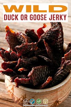 a bowl full of dried beef on top of a wooden table with the title wild duck or goose jerry